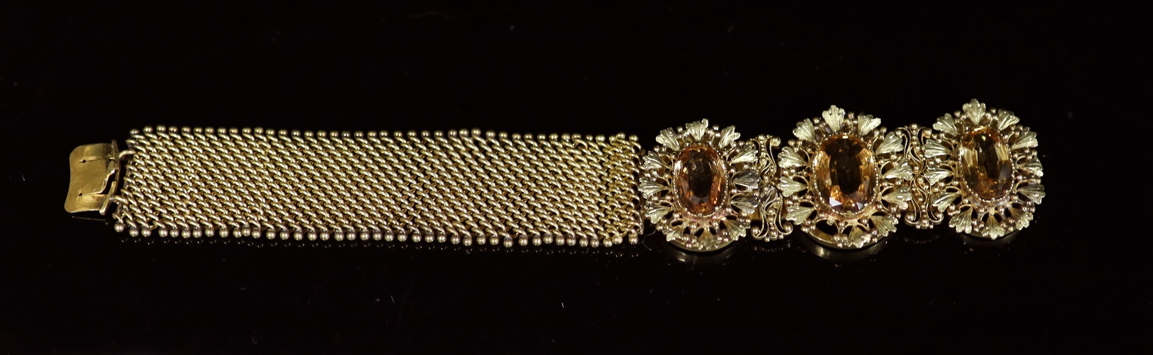 An early 19th century two colour gold and three stone oval cut topaz set bracelet